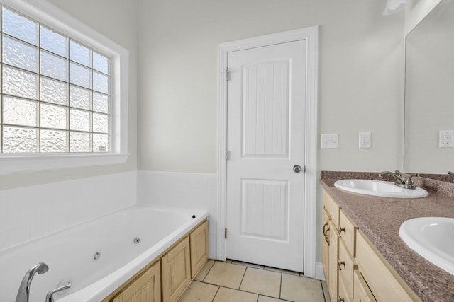 full bath with tile patterned floors, a whirlpool tub, double vanity, and a sink