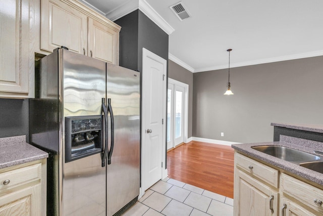 kitchen featuring visible vents, stainless steel fridge with ice dispenser, pendant lighting, ornamental molding, and light tile patterned floors