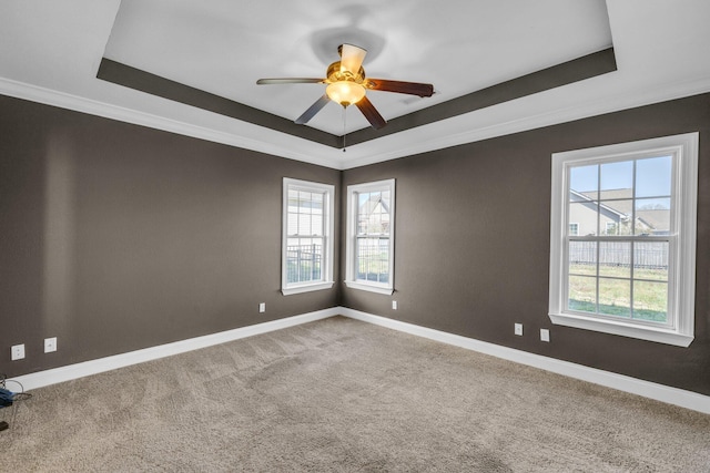 unfurnished room with a raised ceiling and baseboards