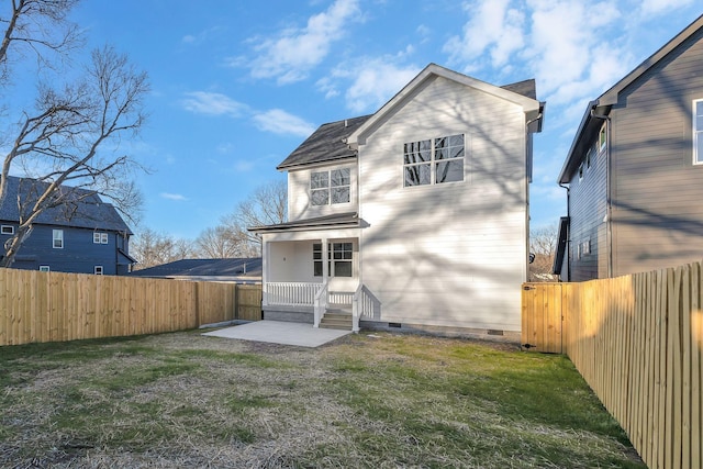 back of house featuring crawl space, a fenced backyard, a patio area, and a yard