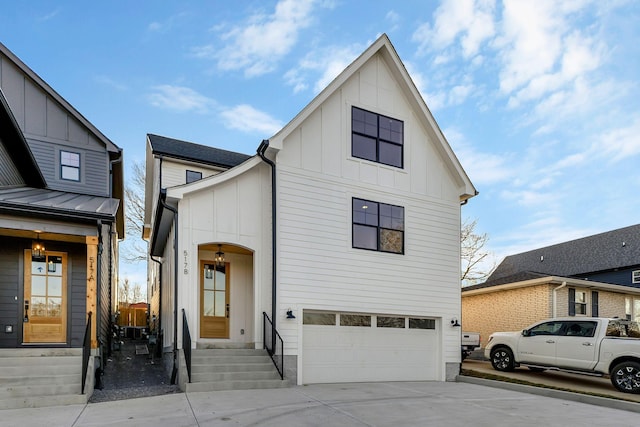 view of front of house with a garage, board and batten siding, and driveway