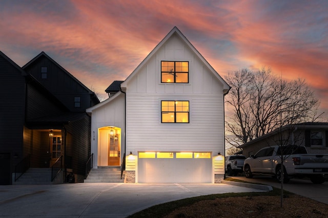 view of front of property featuring board and batten siding, concrete driveway, and an attached garage