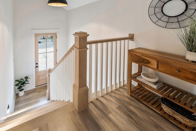 stairs featuring wood finished floors