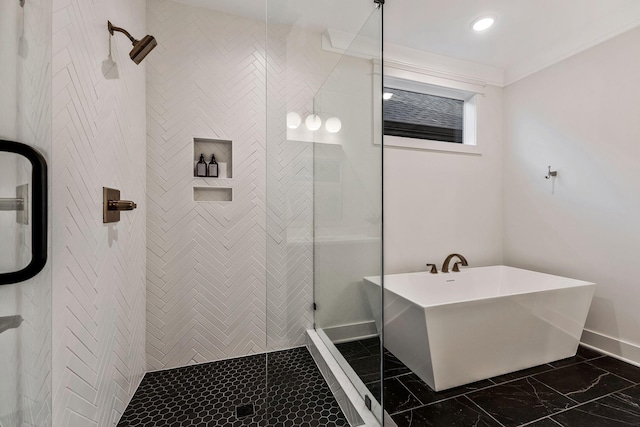 bathroom featuring marble finish floor, a stall shower, crown molding, baseboards, and a soaking tub