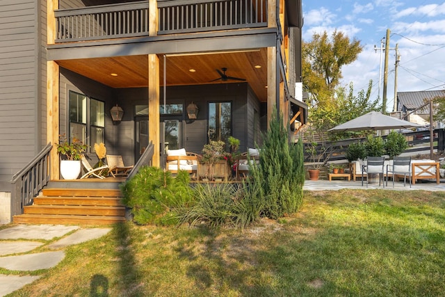 exterior space featuring a patio area, a balcony, and a lawn