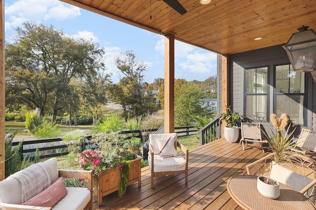 deck with an outdoor hangout area and a ceiling fan