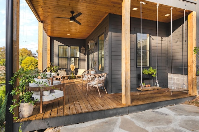 wooden terrace featuring a ceiling fan