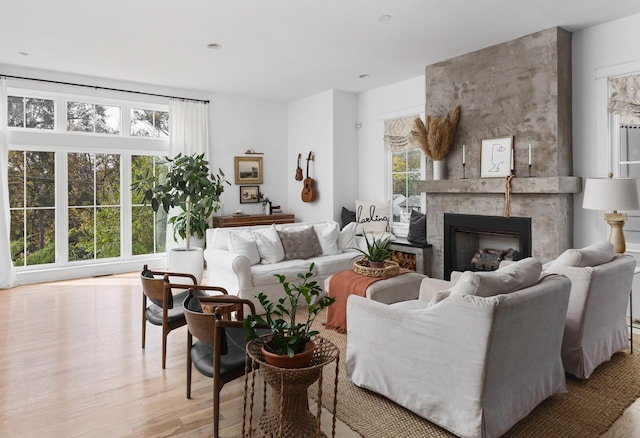 living area with wood finished floors and a premium fireplace