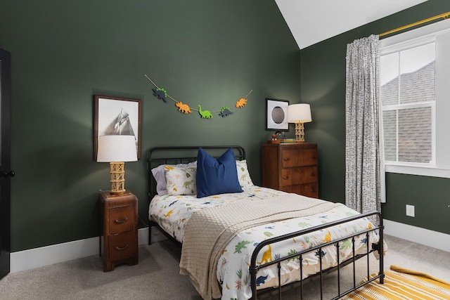 bedroom featuring vaulted ceiling, carpet, and baseboards