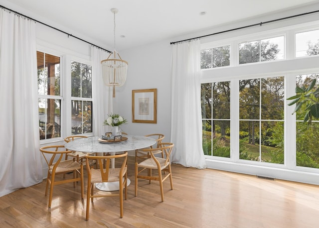 dining area with visible vents and light wood-style flooring