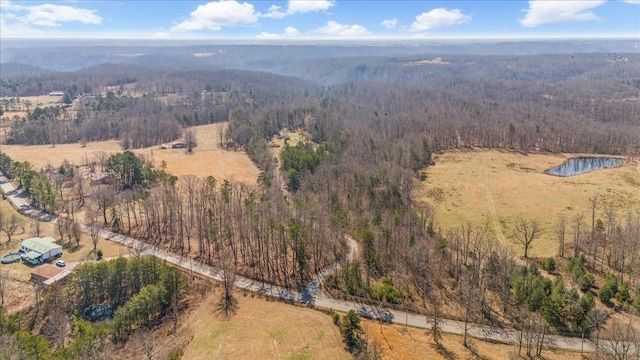 bird's eye view featuring a wooded view