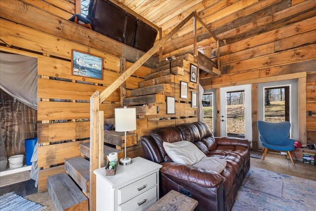 living room featuring high vaulted ceiling, wood ceiling, and wood walls