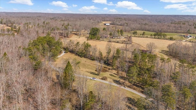 aerial view featuring a rural view and a wooded view