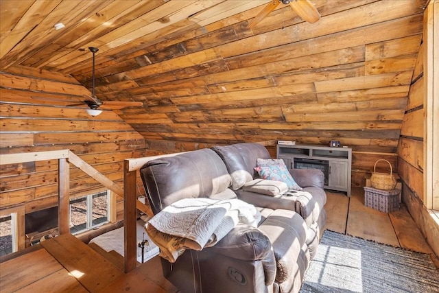 sitting room with a ceiling fan, wood finished floors, wooden walls, lofted ceiling, and wood ceiling