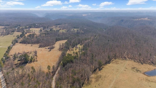 birds eye view of property with a mountain view and a wooded view