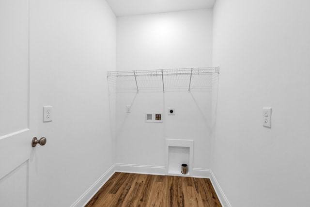 clothes washing area with electric dryer hookup, dark wood-style floors, baseboards, hookup for a washing machine, and laundry area