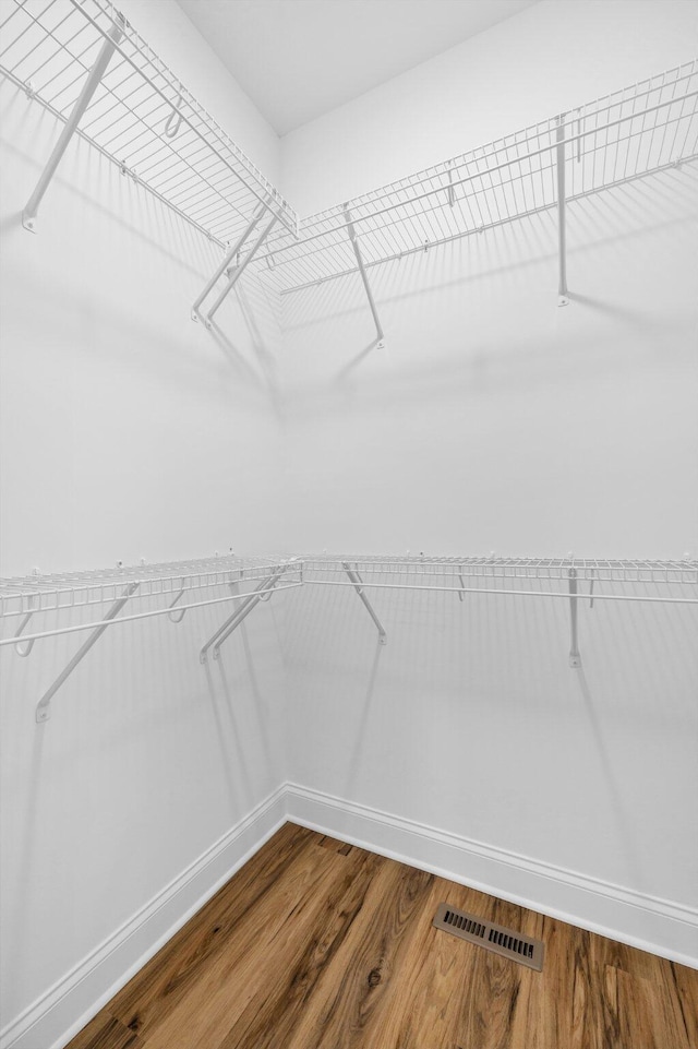 walk in closet featuring visible vents and wood finished floors