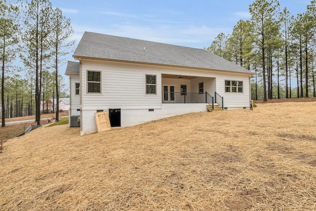 rear view of house with crawl space, roof with shingles, and a ceiling fan