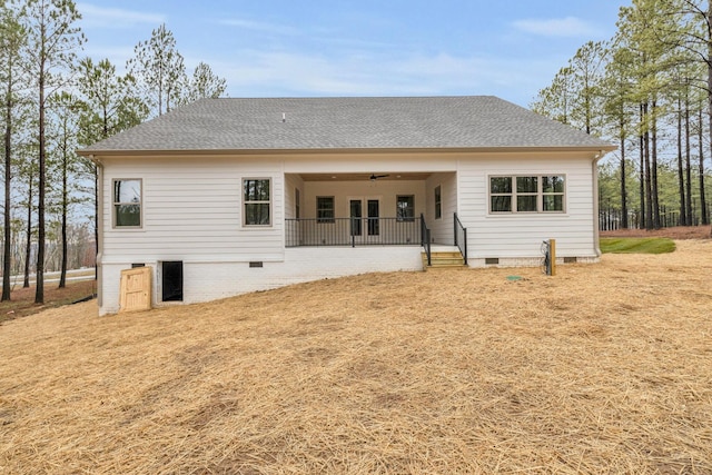 back of house with crawl space, ceiling fan, and roof with shingles