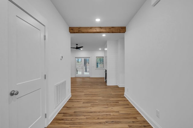 hall featuring baseboards, visible vents, beam ceiling, light wood-style flooring, and recessed lighting