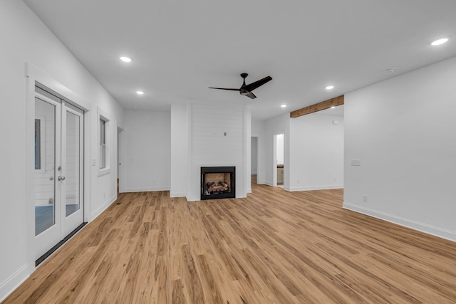 unfurnished living room featuring recessed lighting, a ceiling fan, light wood-type flooring, and baseboards