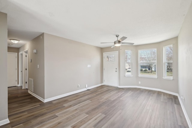 entryway with visible vents, baseboards, a ceiling fan, and wood finished floors