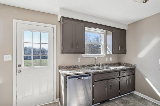 kitchen featuring a sink, baseboards, and stainless steel dishwasher