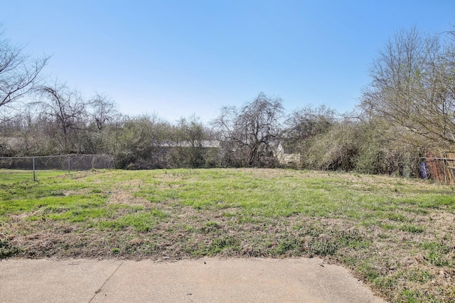 view of yard with a rural view and fence