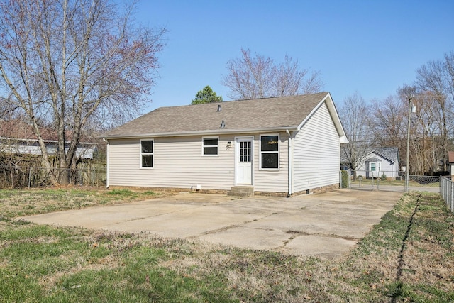 rear view of house featuring a shingled roof, fence, entry steps, crawl space, and a patio