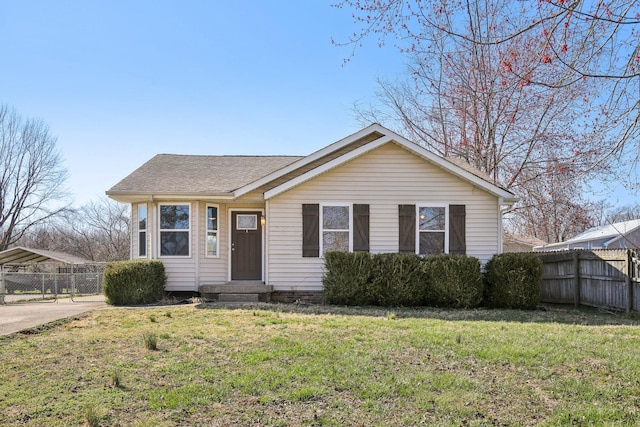 view of front of house featuring a front lawn, fence, and roof with shingles