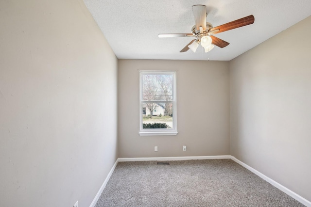 unfurnished room with a textured ceiling, baseboards, ceiling fan, and carpet floors