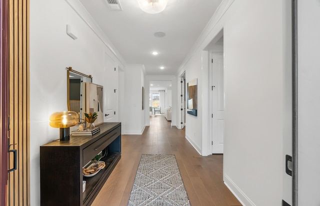 corridor with visible vents, ornamental molding, dark wood-style floors, recessed lighting, and baseboards