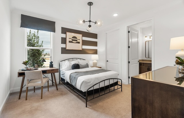 bedroom featuring baseboards, light colored carpet, ensuite bath, and a chandelier