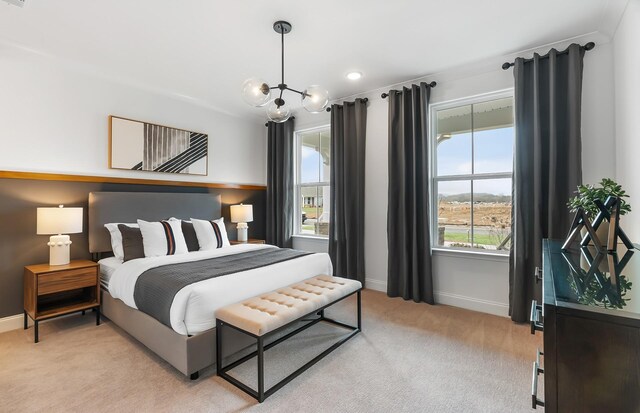 bedroom with a chandelier, light colored carpet, and baseboards