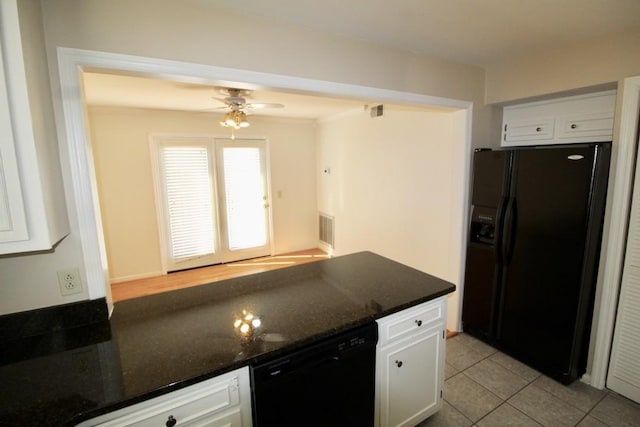 kitchen featuring black appliances, white cabinets, light tile patterned flooring, and dark stone countertops