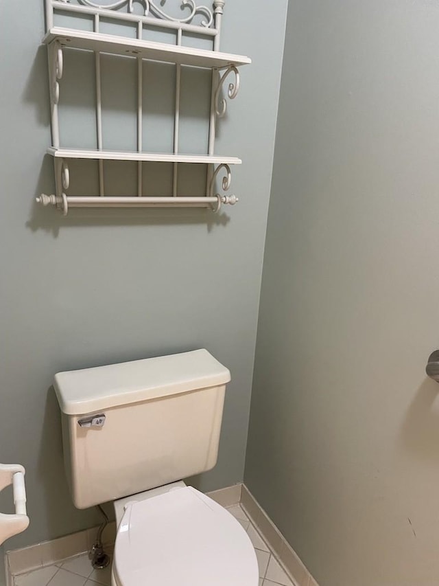 bathroom with tile patterned floors, toilet, and baseboards