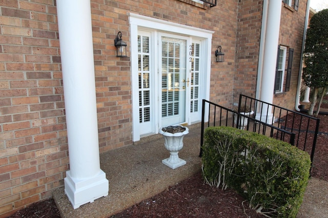 property entrance with brick siding