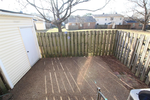 deck featuring cooling unit, a fenced backyard, and a residential view