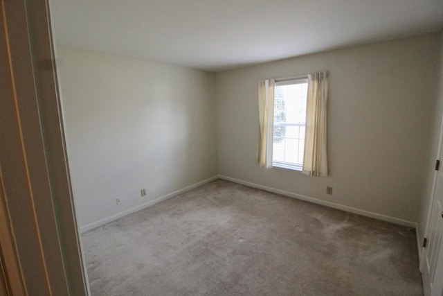 unfurnished room featuring baseboards and carpet floors