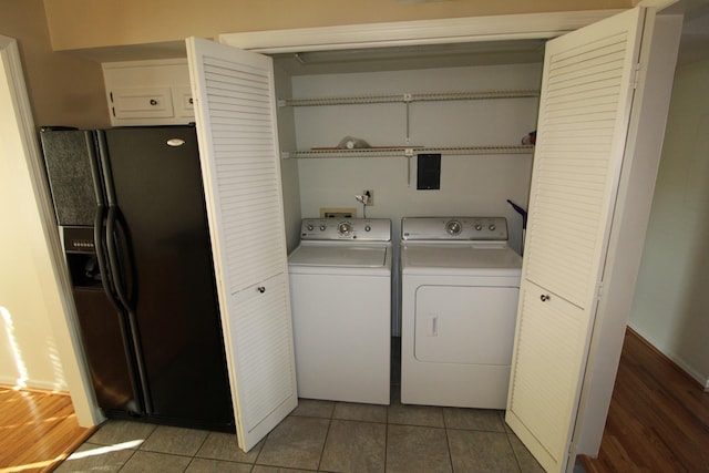 clothes washing area featuring washer and dryer, laundry area, and tile patterned floors