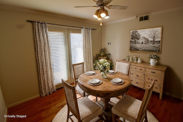 dining space with wood finished floors, baseboards, visible vents, ceiling fan, and crown molding