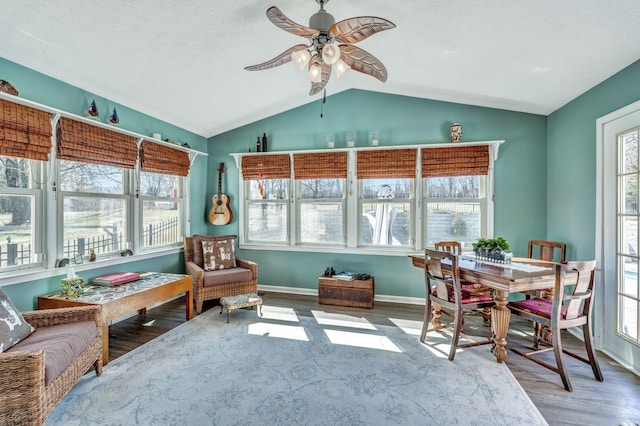 sunroom featuring lofted ceiling, plenty of natural light, and ceiling fan