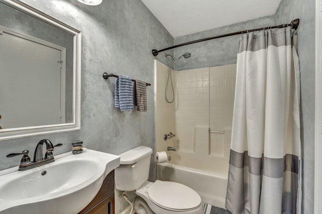 bathroom featuring shower / bath combo with shower curtain, toilet, a textured ceiling, vanity, and a textured wall