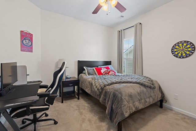 carpeted bedroom with visible vents, a ceiling fan, and baseboards