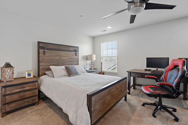 carpeted bedroom featuring visible vents and a ceiling fan