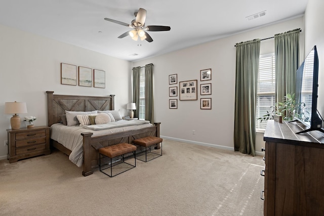 bedroom with light carpet, visible vents, ceiling fan, and baseboards