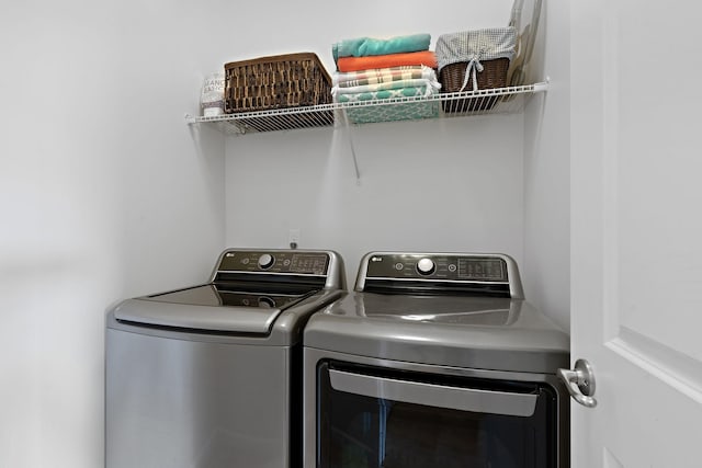 laundry room with laundry area and washing machine and clothes dryer