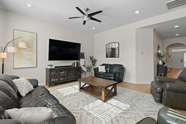 living area with visible vents, ceiling fan, recessed lighting, light wood-style floors, and arched walkways