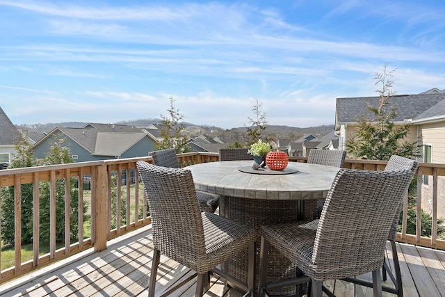 deck with a residential view and outdoor dining space