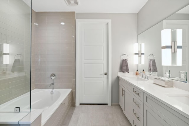 bathroom featuring visible vents, double vanity, a sink, tile patterned flooring, and tiled shower / bath combo